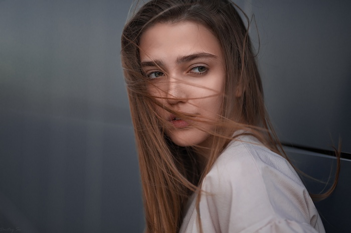 Woman with windblown hair looking away