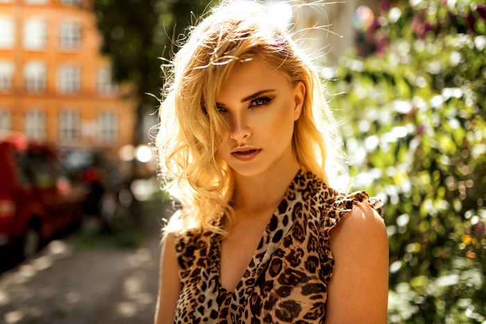 Portrait of a blonde woman with a leopard print dress