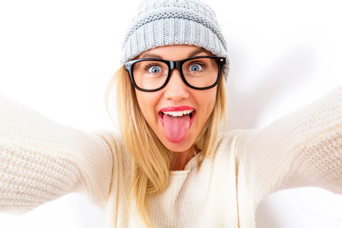 Woman with glasses sticking out her tongue