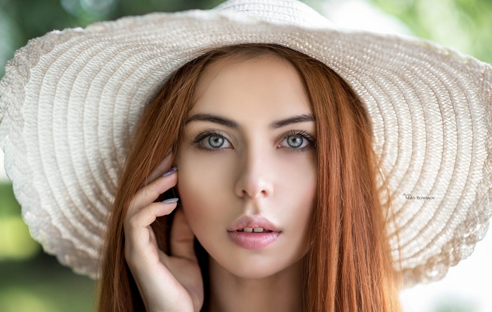 Woman with red hair wearing a hat