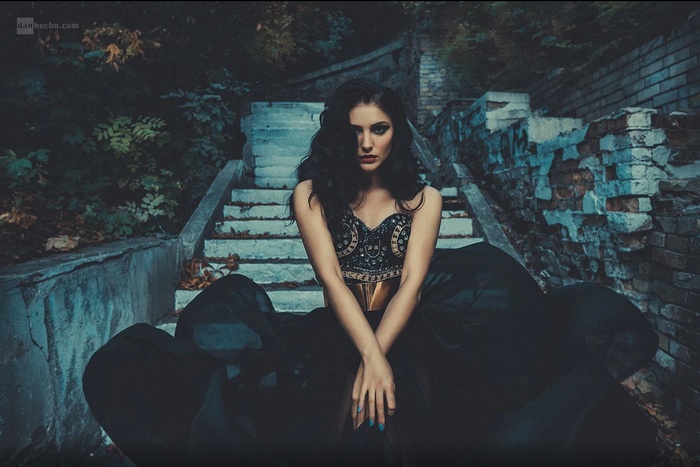 Woman in black dress on outdoor stairs