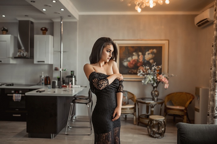 Woman in black dress in a modern apartment
