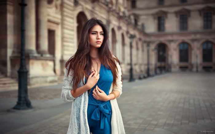 Woman in blue dress and white cardigan in Paris