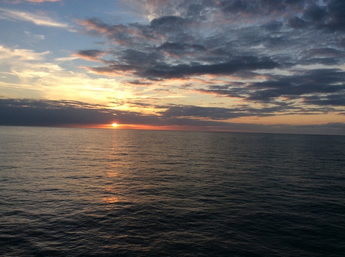 Sunset over the ocean with clouds