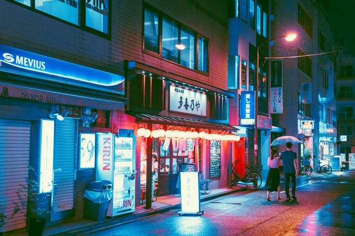 Japanese street with Mevius and Kirin signs at night