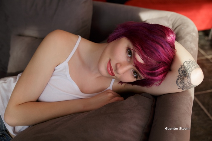 Woman with purple dyed hair and tattoo