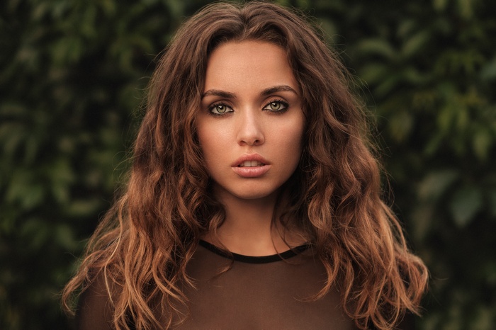 Portrait of a woman with curly brown hair