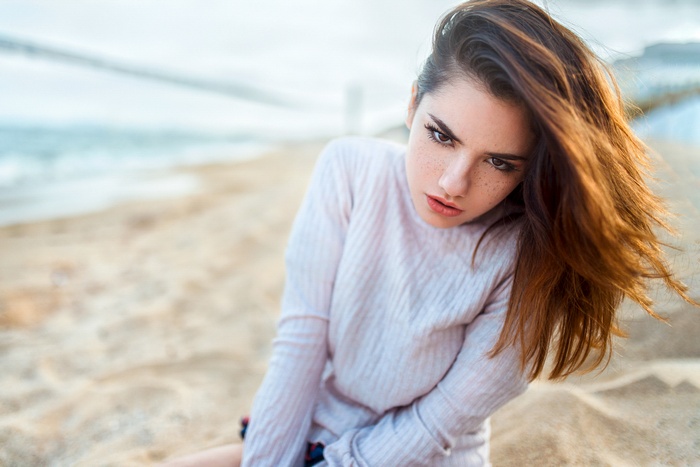 Woman with freckles on a beach