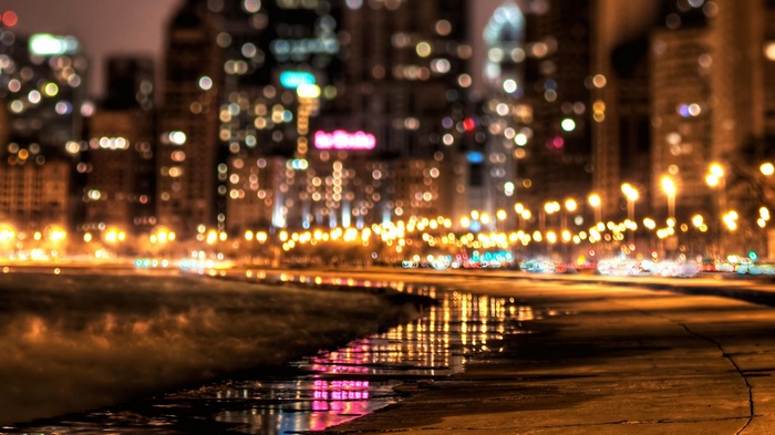 Cityscape at night with bokeh lights and reflections