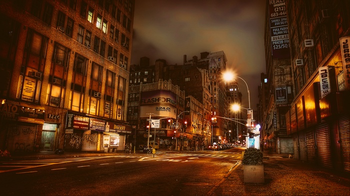 New York City street at night with flashing signs