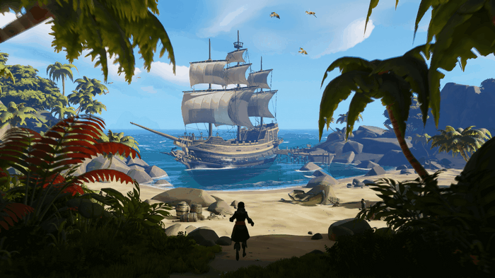Pirate ship docked at a tropical island in Sea of Thieves