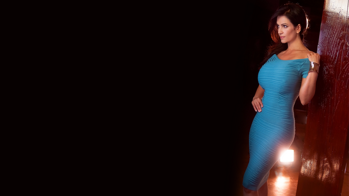 Denise Milani in a blue dress