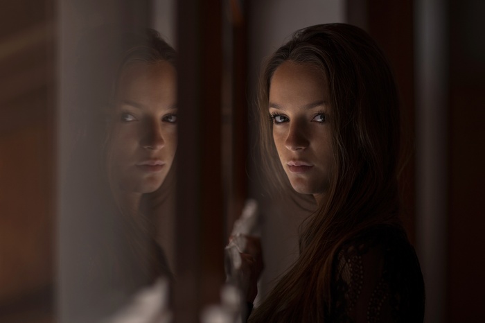 Woman with long brown hair looking at the viewer
