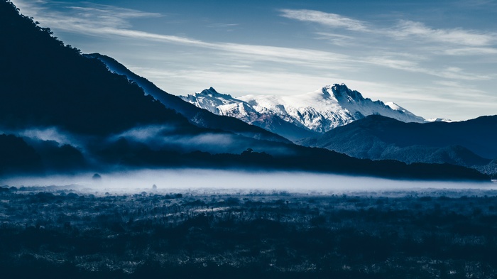 Misty mountains with snow-capped peaks