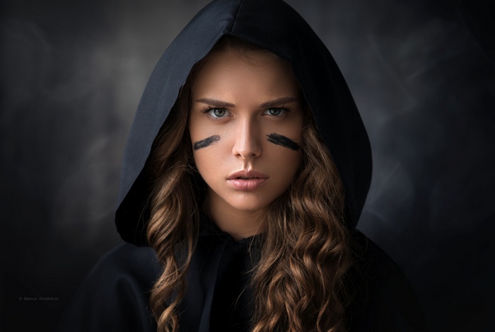 Lana in a black hood with face paint