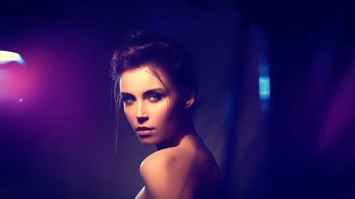 Woman with smoky eyes and purple lighting