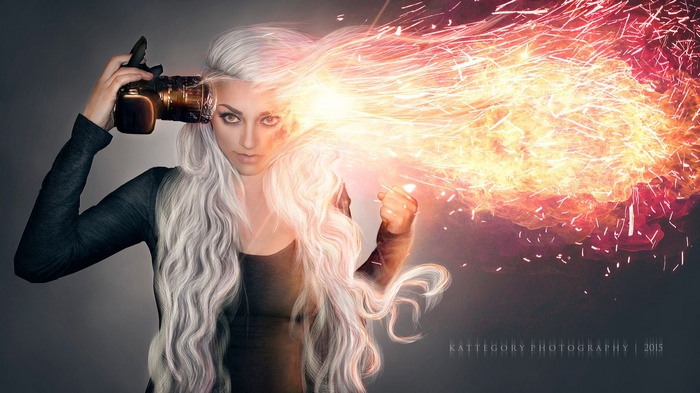 Woman with camera and fire explosion from head