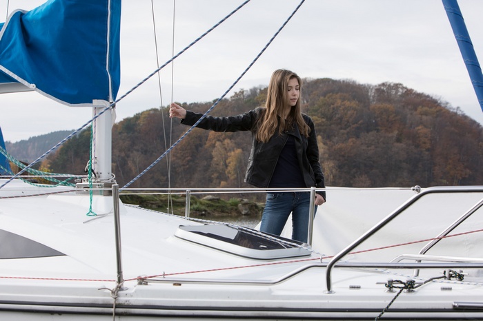 Woman on a sailboat holding a rope