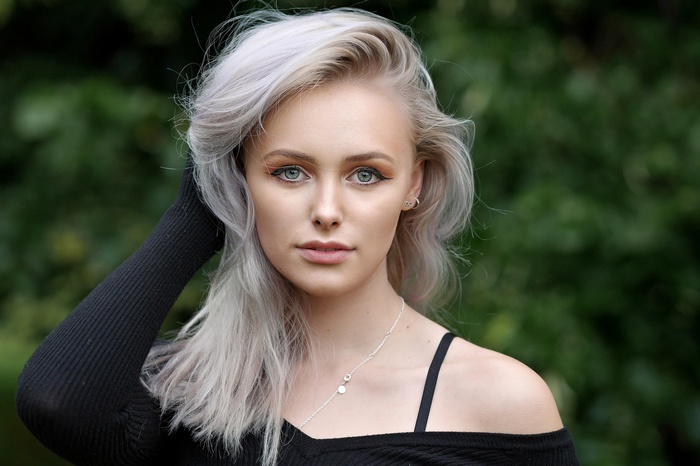 Portrait of a young woman with blonde hair outdoors