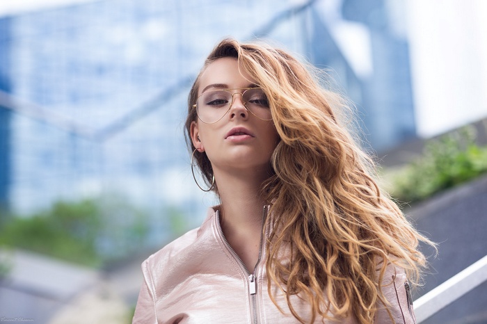 Woman with blonde hair and glasses