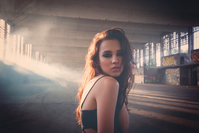 Woman posing in abandoned building with smoke