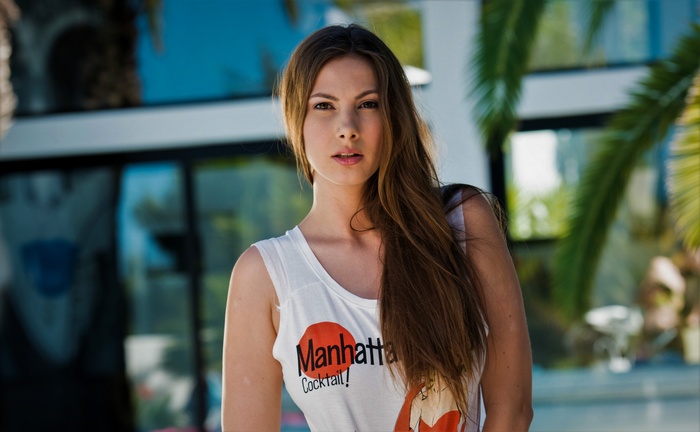 Conny Lior wearing a white tank top