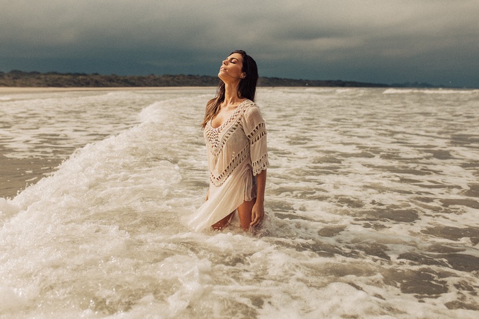 Woman in a white dress in the ocean