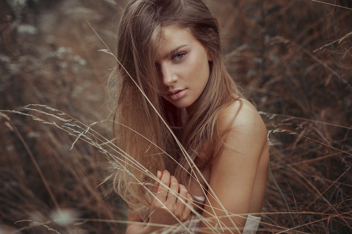 Portrait of a blonde woman in tall grass