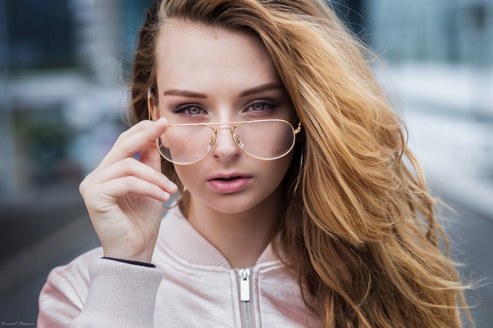 Woman with blonde hair wearing glasses