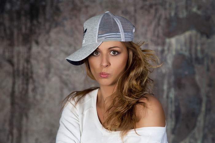 Woman wearing Adidas hat and white shirt