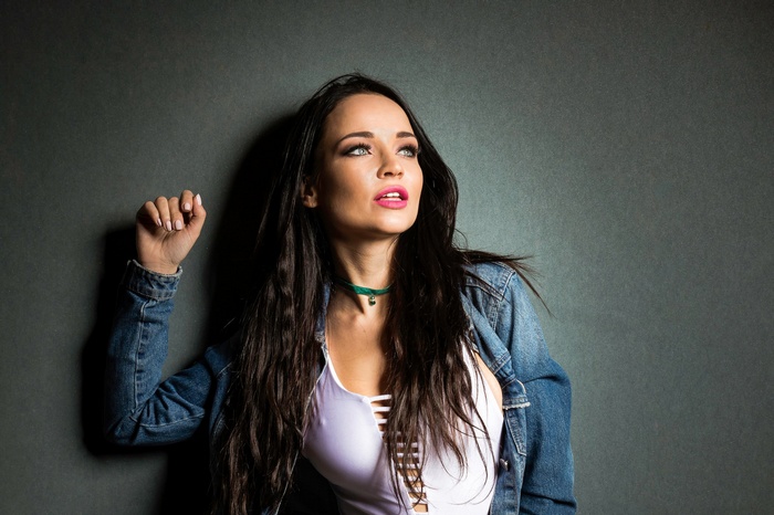 Angelina Petrova with long dark hair wearing a denim jacket