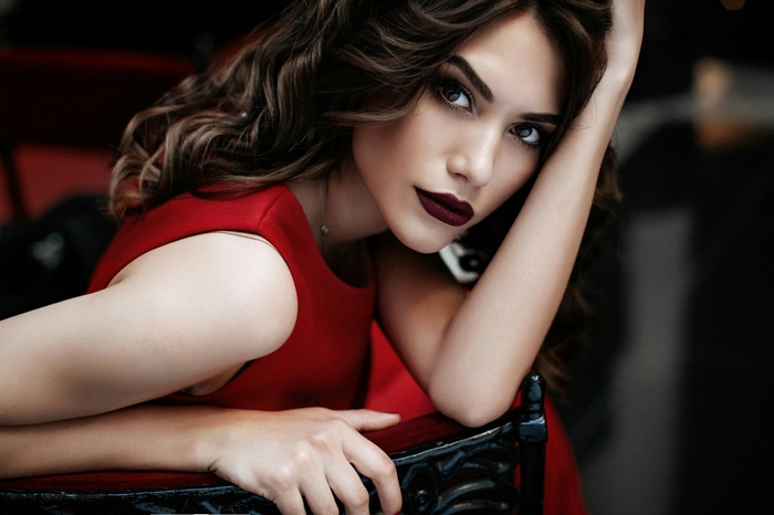 Rina Shuster in a red dress with dark lipstick