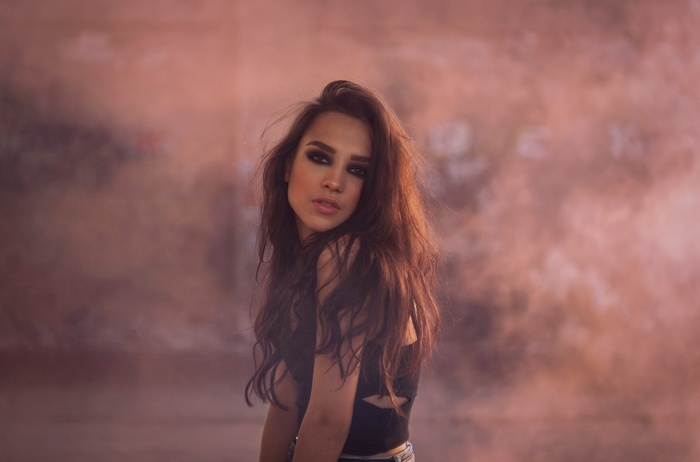 Woman with dark makeup and long brown hair