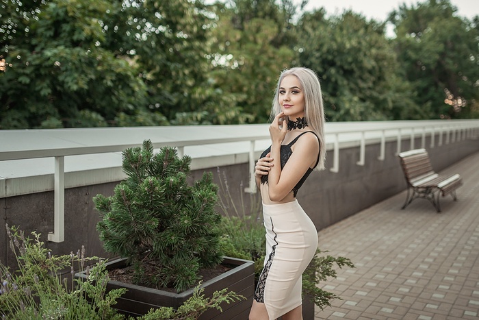 Woman in black top and skirt outdoors