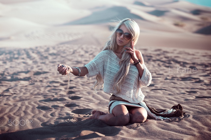 Woman in desert holding sand