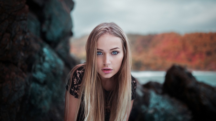 Woman with blonde hair and blue eyes outdoors