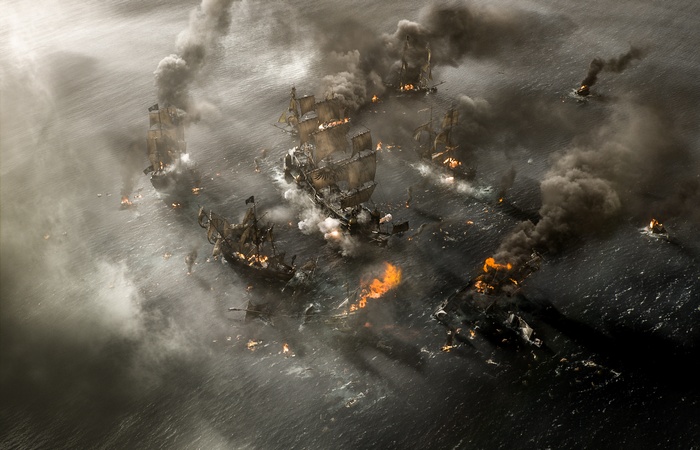 Pirates of the Caribbean battle scene with burning ships