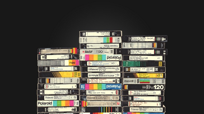 Stack of VHS tapes with handwritten labels