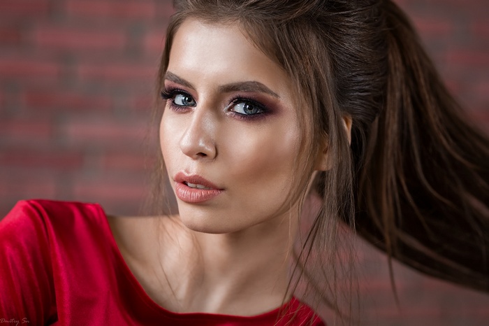 Woman with dramatic makeup and red dress