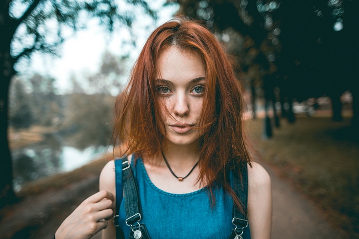 Redhead woman wearing overalls and necklace