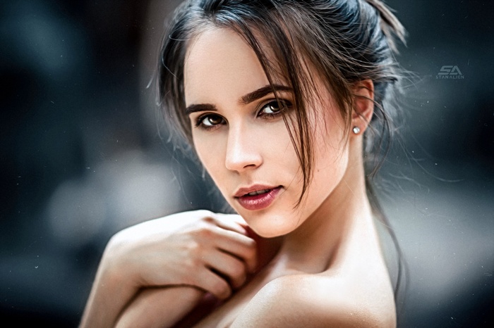 Woman with dark hair and a diamond earring