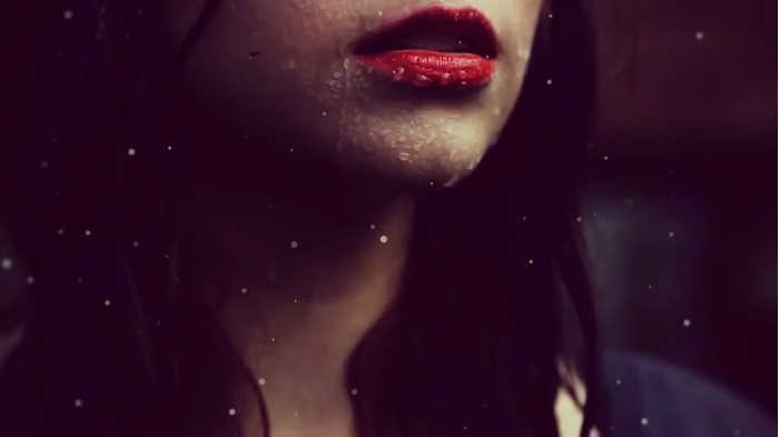 Close-up of woman's lips with water droplets