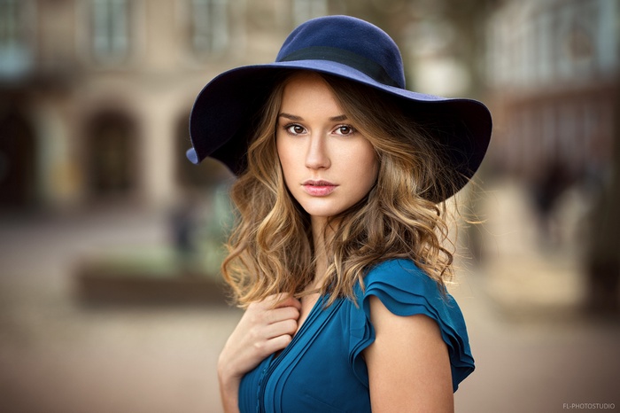 Woman wearing a blue hat and dress, portrait