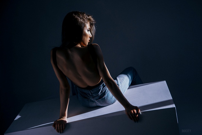 Woman in jeans with bare shoulders