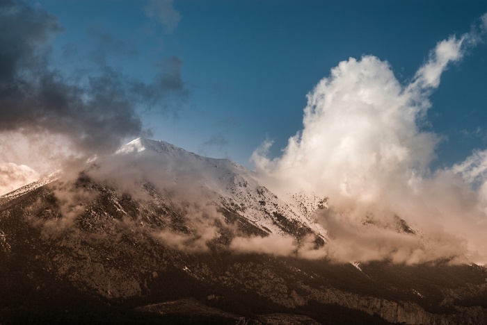 Snow-capped mountain peak shrouded in clouds