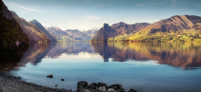 Mountains reflecting in a calm lake at sunrise