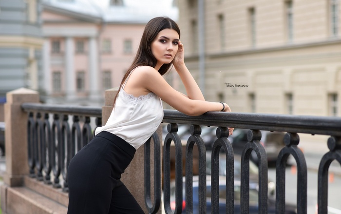 Woman leaning on a railing outdoors