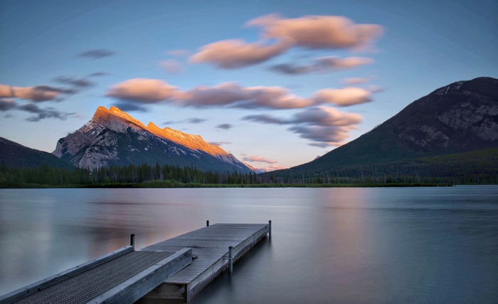 Mountain lake with pier at sunset