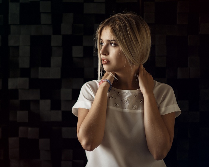 Woman with blonde hair looking away