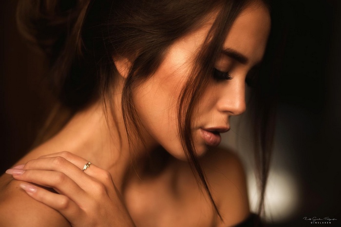 Woman's profile with hand on shoulder